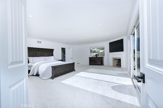 bedroom with carpet, visible vents, a fireplace, and recessed lighting