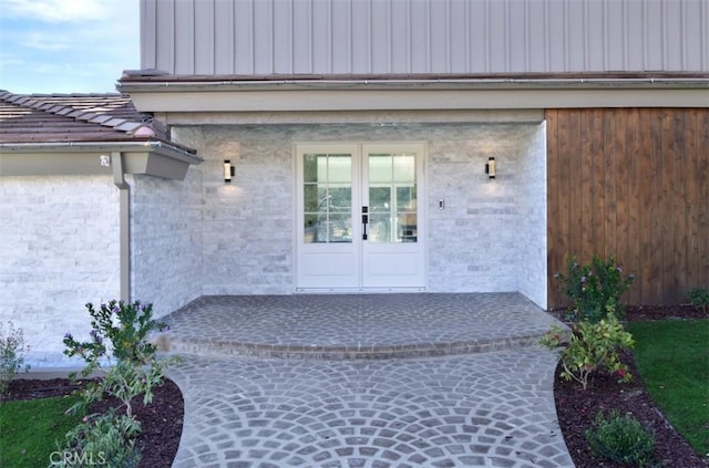 property entrance with french doors and a tiled roof