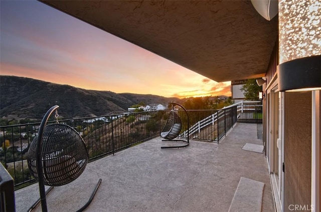 balcony at dusk with a mountain view