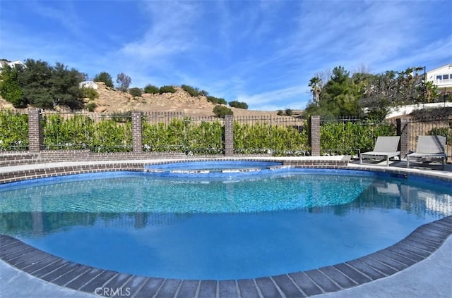 view of swimming pool with fence and a fenced in pool