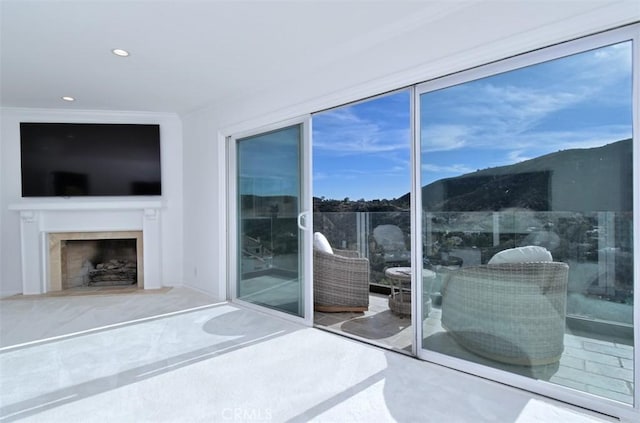 bedroom with a fireplace with flush hearth, recessed lighting, and crown molding