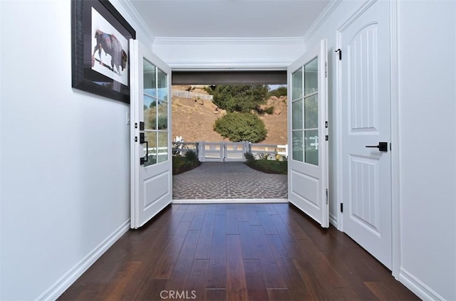 doorway with dark hardwood / wood-style flooring and ornamental molding