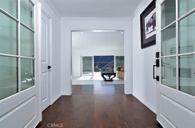 hallway with dark hardwood / wood-style flooring and crown molding