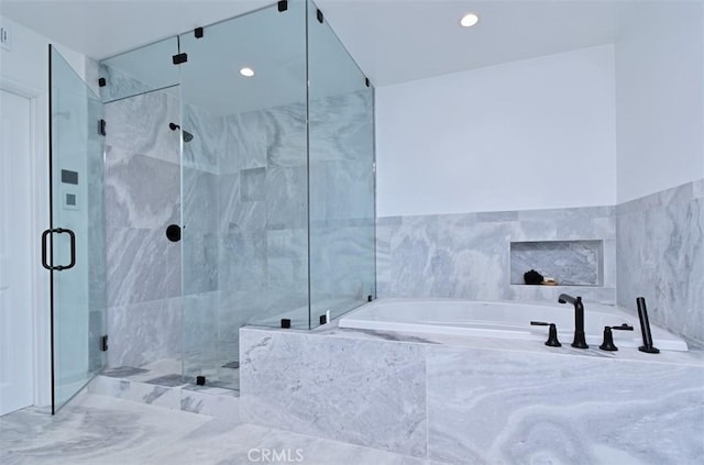 bathroom with a marble finish shower and a bath