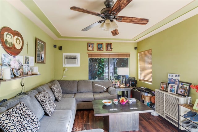 living room featuring ceiling fan, dark hardwood / wood-style flooring, and a wall mounted air conditioner