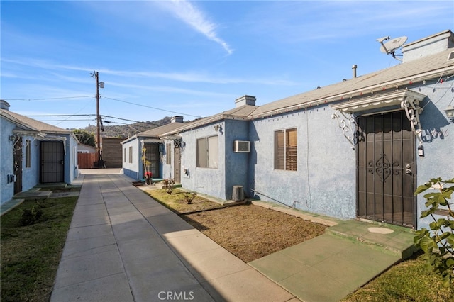 view of side of home featuring a wall mounted AC