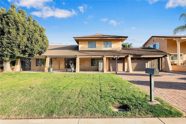 view of front of property featuring a front lawn and a garage