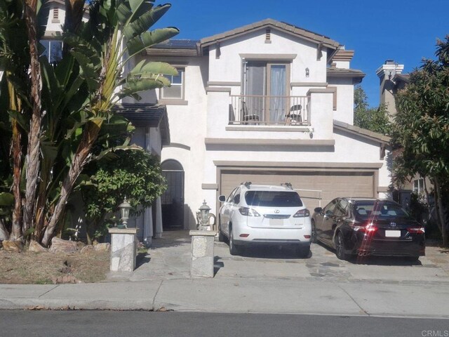 view of front of home featuring a balcony and a garage