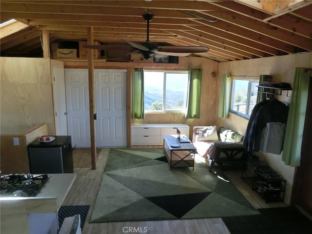 interior space featuring ceiling fan, hardwood / wood-style flooring, and vaulted ceiling