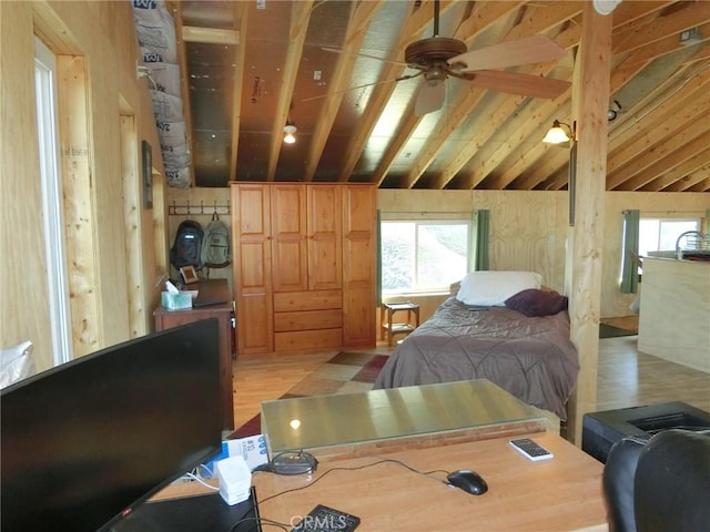 bedroom with light wood-type flooring, vaulted ceiling, and ceiling fan