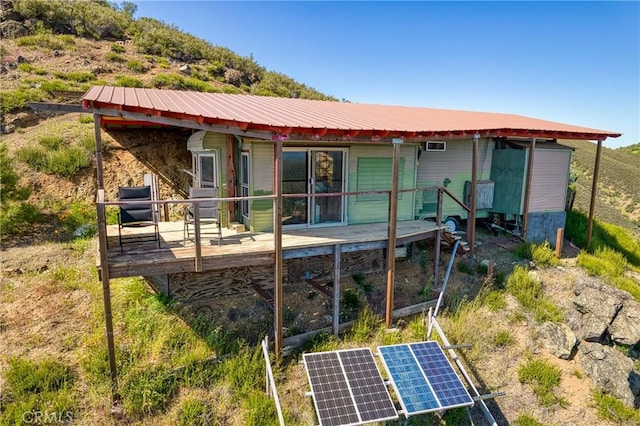 back of property featuring solar panels