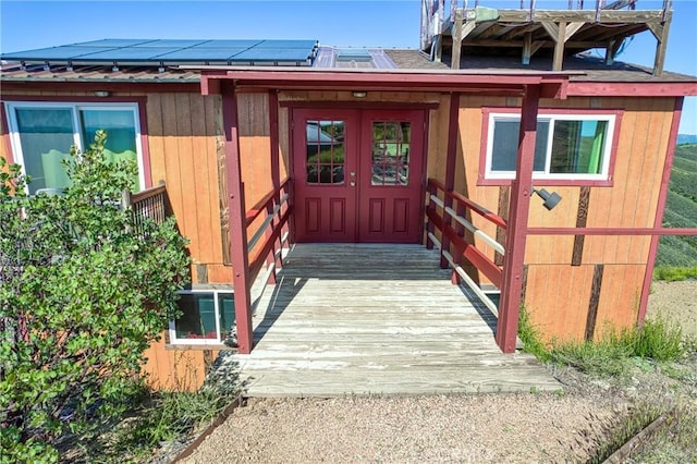 view of exterior entry with solar panels