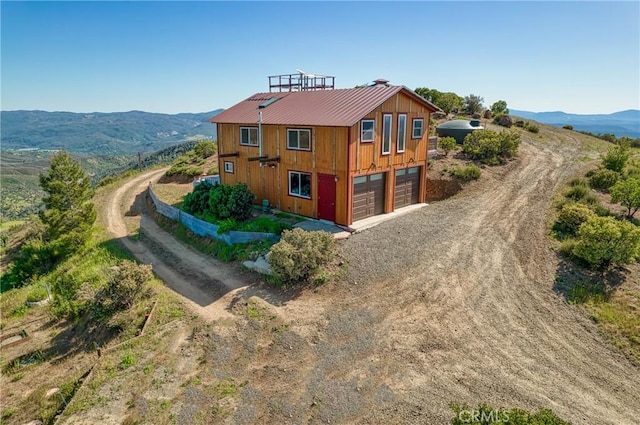 exterior space with a garage and a mountain view