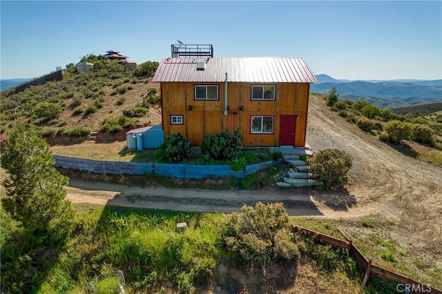 rear view of property featuring a mountain view