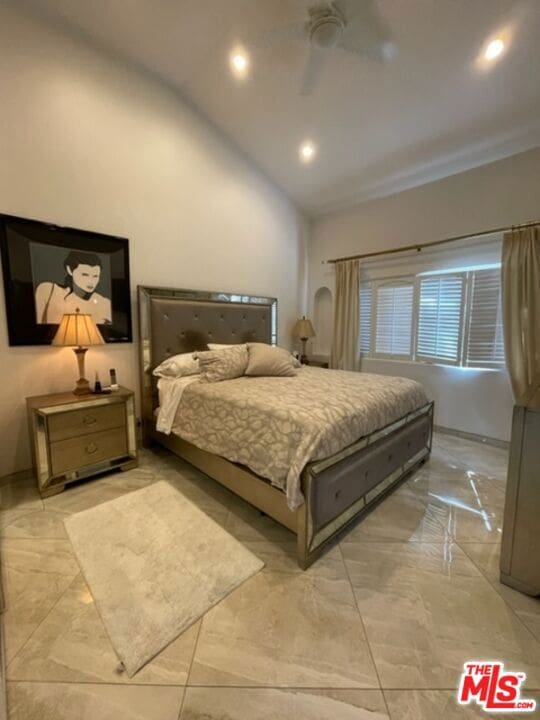 bedroom featuring ceiling fan and vaulted ceiling