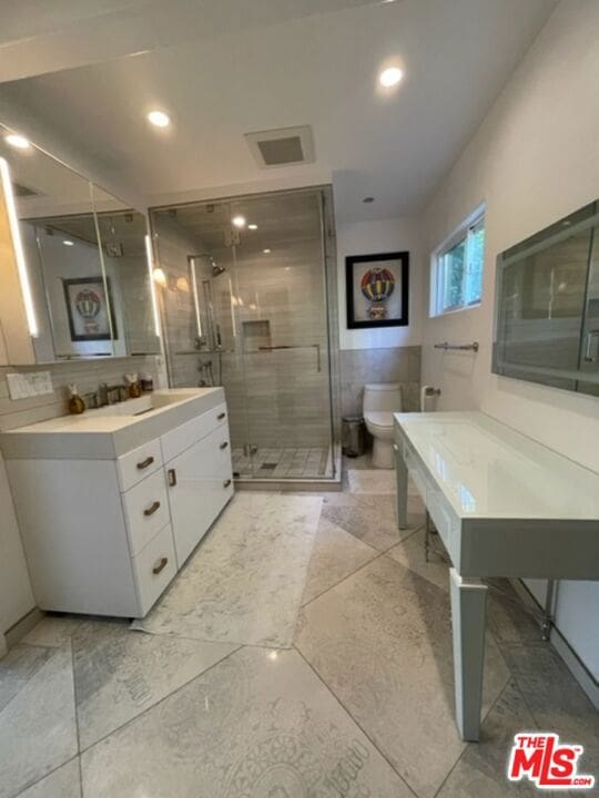 bathroom featuring toilet and vanity