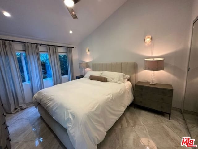 bedroom featuring vaulted ceiling and ceiling fan