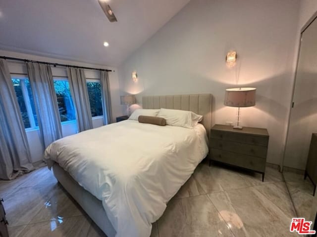 bedroom with ceiling fan and vaulted ceiling