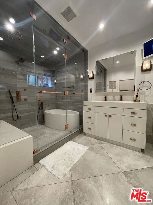 bathroom with vanity and plus walk in shower