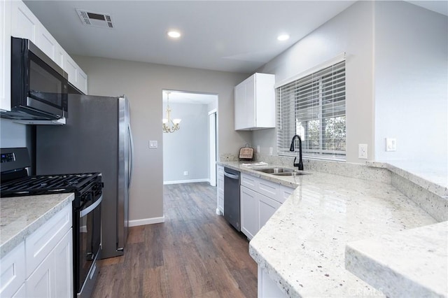 kitchen with appliances with stainless steel finishes, sink, white cabinetry, and light stone countertops