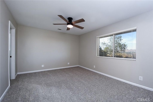 empty room with ceiling fan and carpet flooring