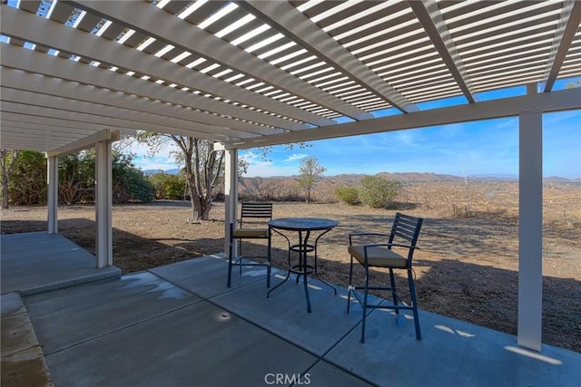 view of patio / terrace featuring a pergola and a mountain view