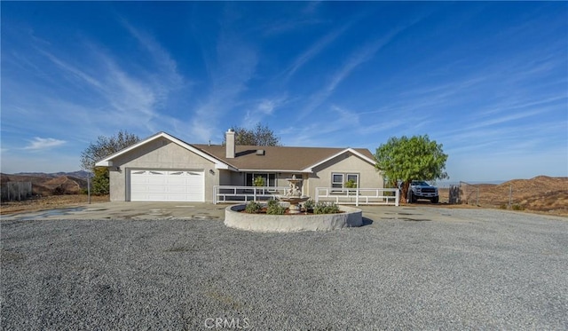 ranch-style house with a mountain view and a garage