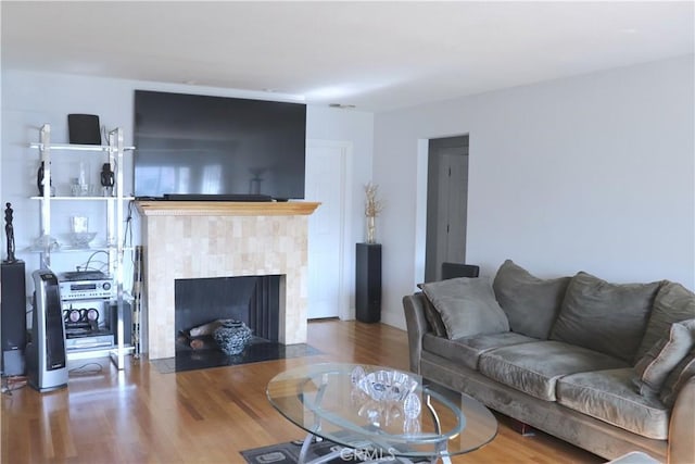 living room with hardwood / wood-style floors and a fireplace