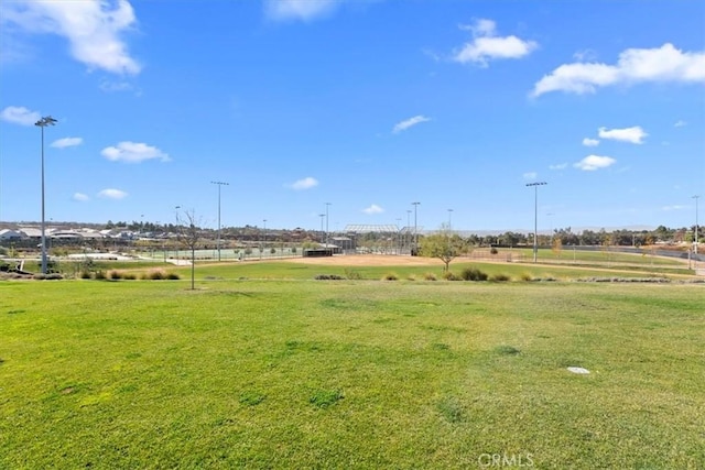 surrounding community with a yard and a rural view