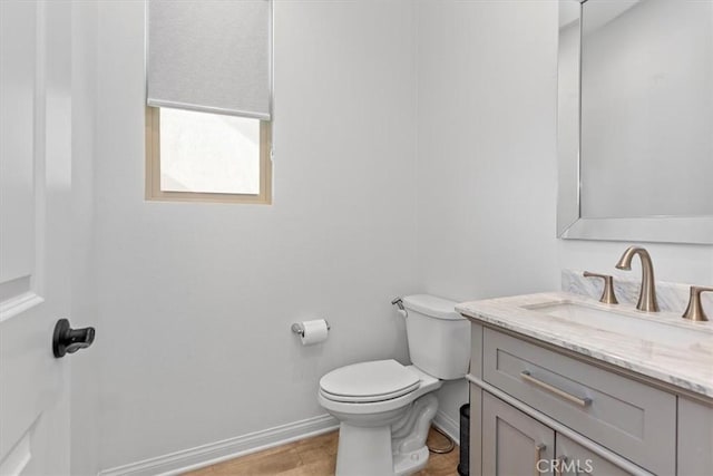 bathroom featuring toilet and vanity