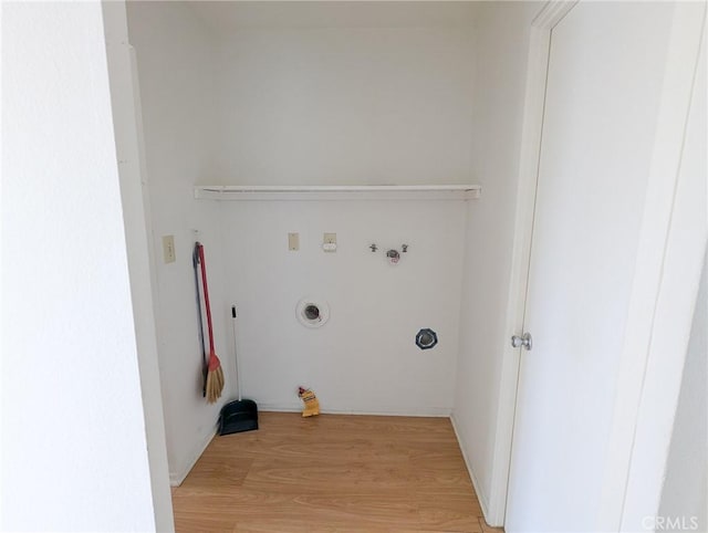 washroom featuring washer hookup, hookup for a gas dryer, and light hardwood / wood-style flooring