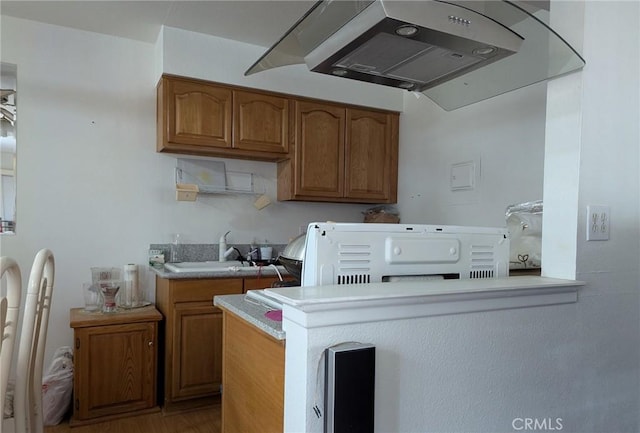 laundry area with hardwood / wood-style flooring, sink, and washer / dryer