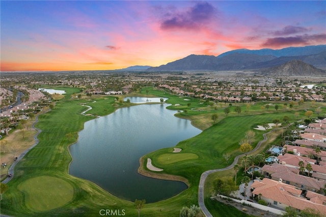 aerial view at dusk with a water and mountain view