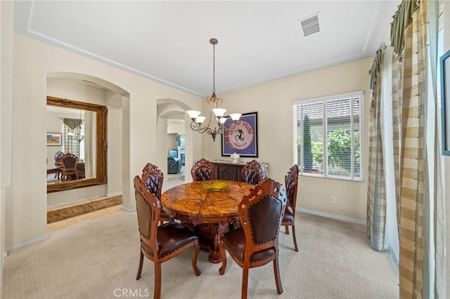 dining room featuring an inviting chandelier and light carpet