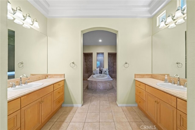 bathroom featuring a raised ceiling, a bathing tub, tile patterned floors, and vanity