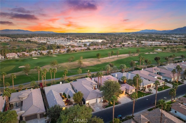 aerial view at dusk featuring a mountain view