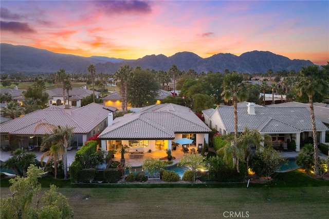 aerial view at dusk featuring a mountain view