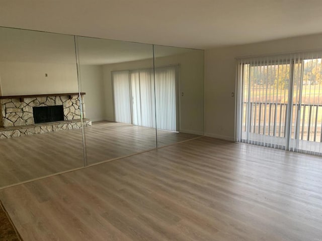 unfurnished living room with a fireplace and hardwood / wood-style flooring