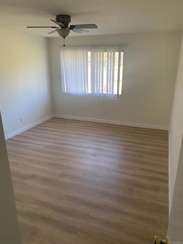 unfurnished room with ceiling fan and hardwood / wood-style floors