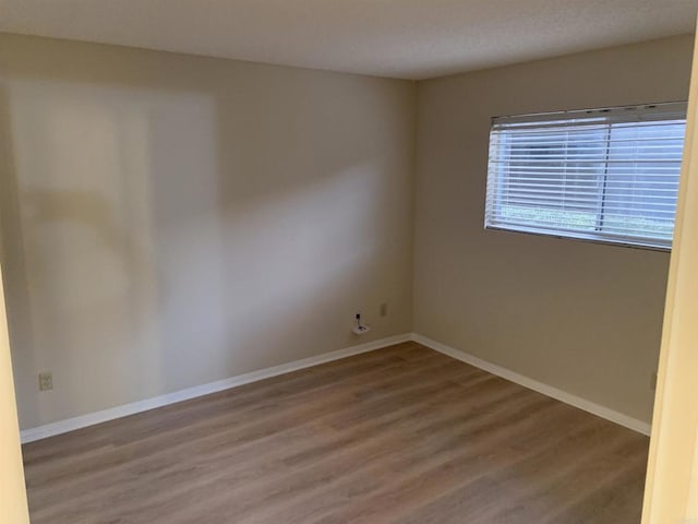 empty room with hardwood / wood-style floors