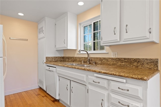 kitchen with light wood-type flooring, white appliances, white cabinetry, and sink