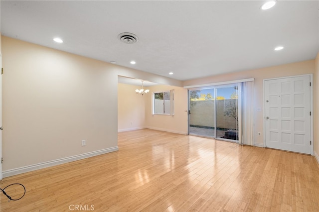 interior space with a chandelier and light hardwood / wood-style floors