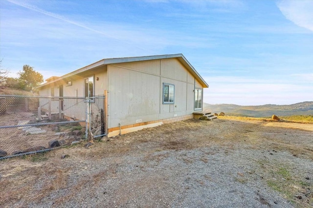 view of property exterior with a mountain view