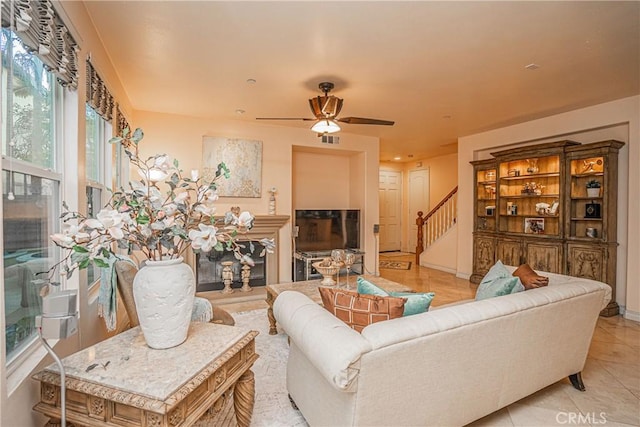 tiled living room with ceiling fan