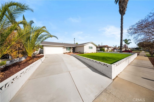 view of front facade with a front yard and a garage