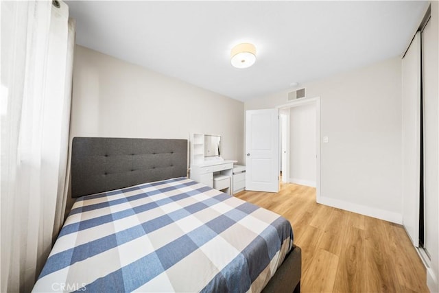 bedroom featuring light hardwood / wood-style floors and a closet