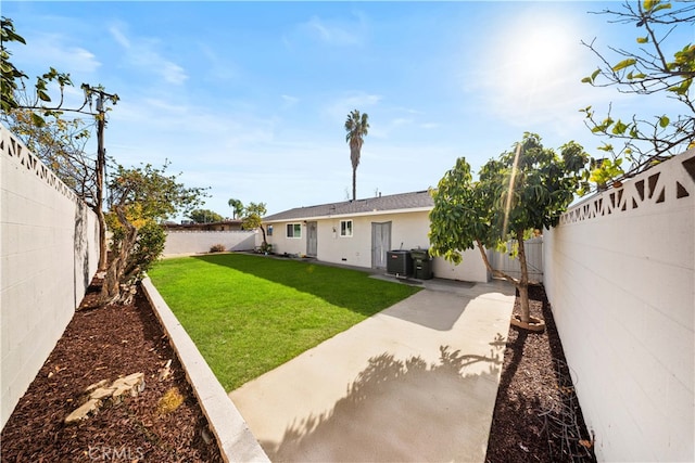 view of yard with central AC unit and a patio area