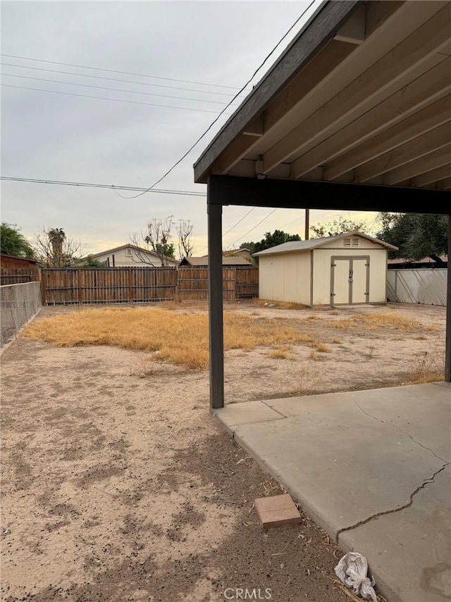 view of yard featuring a patio area and a storage shed