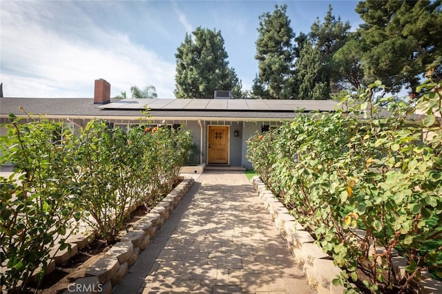 view of front of property featuring solar panels