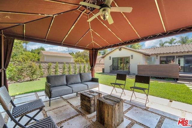 view of patio / terrace featuring ceiling fan, a gazebo, and an outdoor living space